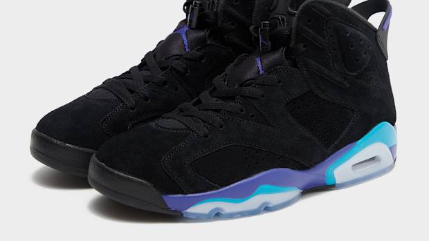 Side view of black, purple, and aqua Air Jordan sneakers.